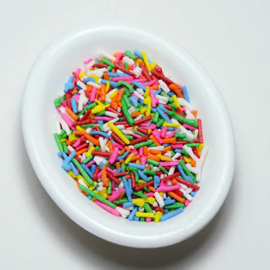 Variedad de grageas comestibles en diferentes colores y tamaños para decoración de repostería. Paquetes de 50 gramos de chispas dulces para tortas y cupcakes.