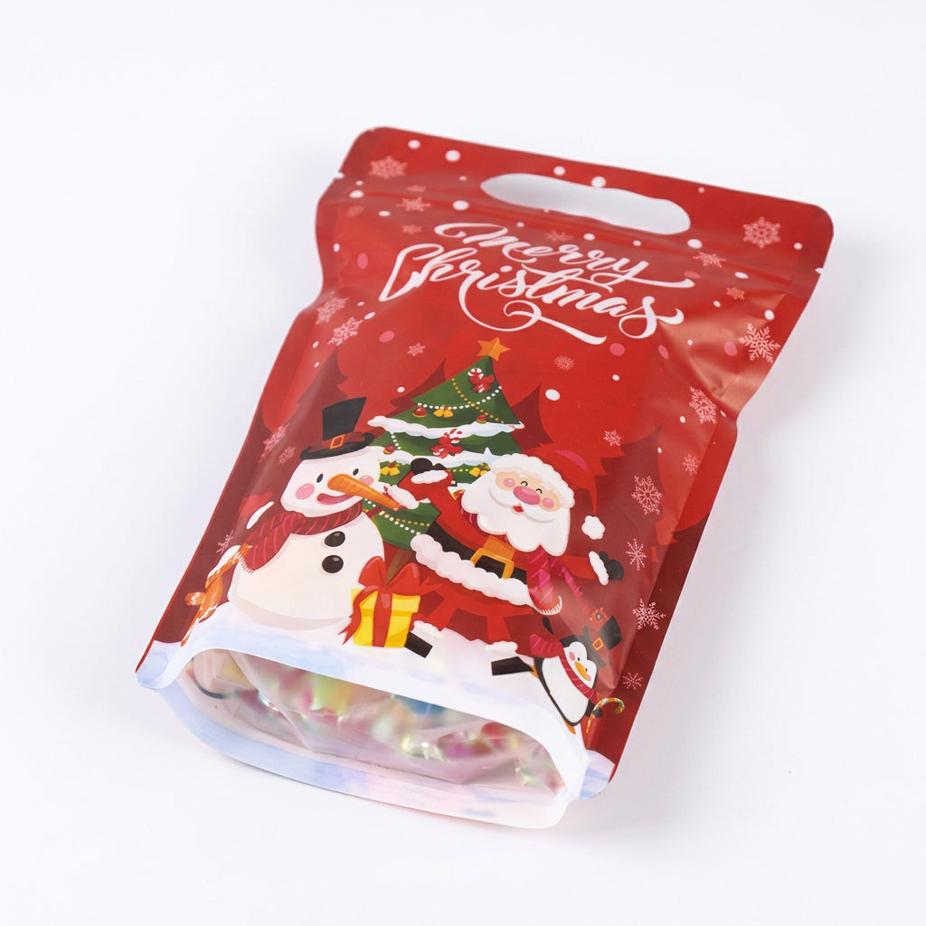 Bolsa de regalo navideña Vallia Repostería roja con diseño de Papá Noel, muñeco de nieve y asa troquelada