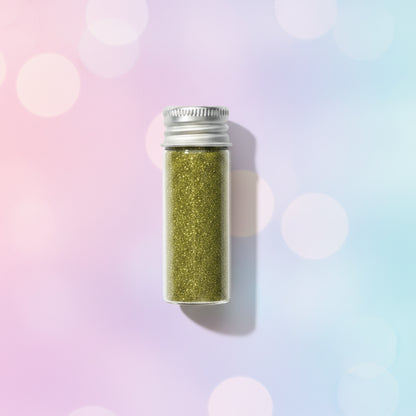 Escarcha comestible glitter dorado en frasco de vidrio 10 gr sobre fondo bokeh pastel multicolor – glitter para tortas y repostería - Vallia Reposteria