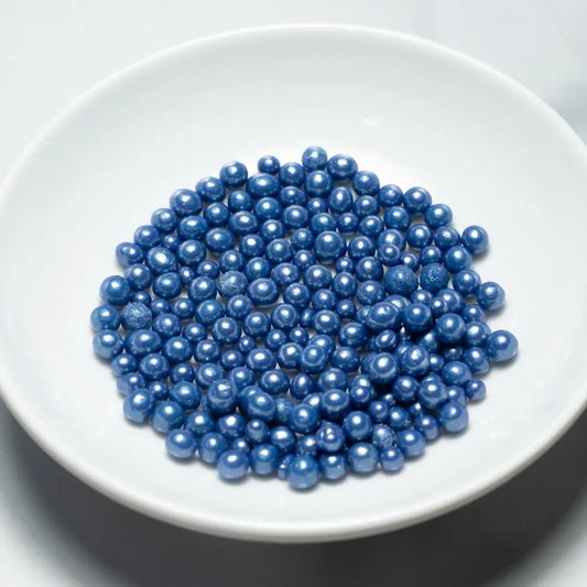 Grageas comestibles coloridas en paquete de 50g para decoración de tortas, cupcakes y galletas. Variedad de colores y tamaños para repostería profesional.