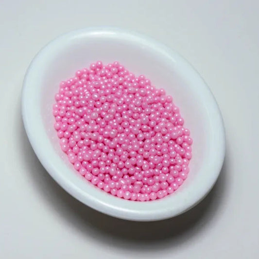 Grageas comestibles coloridas en paquete de 50g para decoración de tortas, cupcakes y galletas. Variedad de colores y tamaños para repostería profesional.