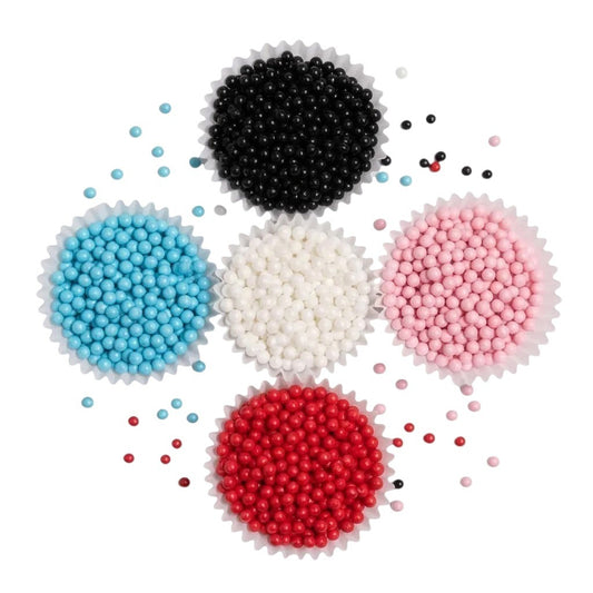 Capacillos con grageas perladas comestibles de Vallia Repostería en azul, negra, blanca, rosada y roja
