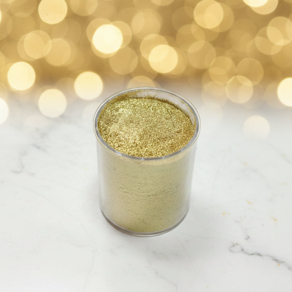 Polvo matizador comestible color oro brillante en frasco transparente con fondo bokeh dorado – colorante para repostería