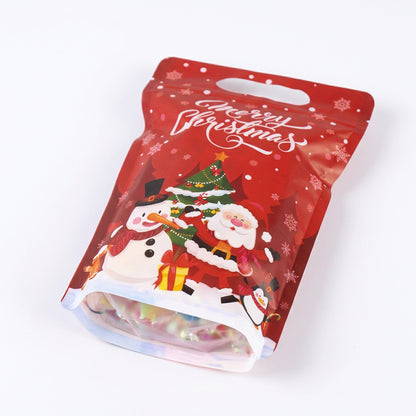 Bolsa de regalo navideña Vallia Repostería roja con diseño de Papá Noel, muñeco de nieve y asa troquelada