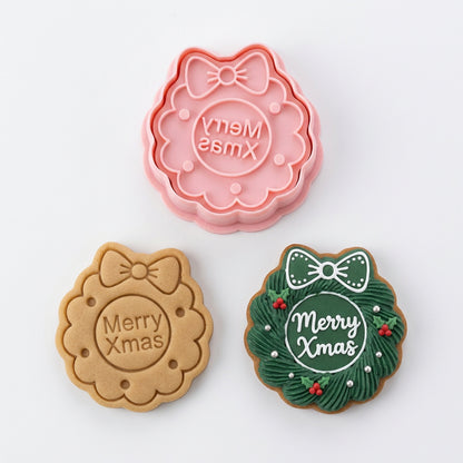 Cortador de galletas Vallia Repostería con diseño de corona navideña y mensaje Merry Xmas en plástico rosa