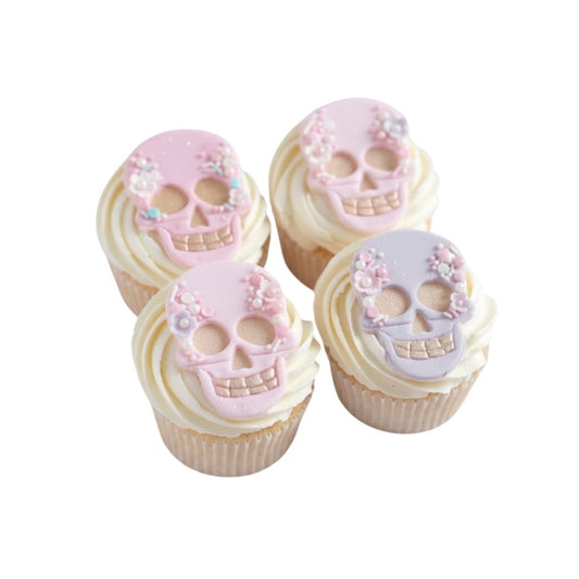Cupcakes decorados con calaveras estilo Catrina de Vallia Repostería, hechos con fondant en tonos pastel y flores.