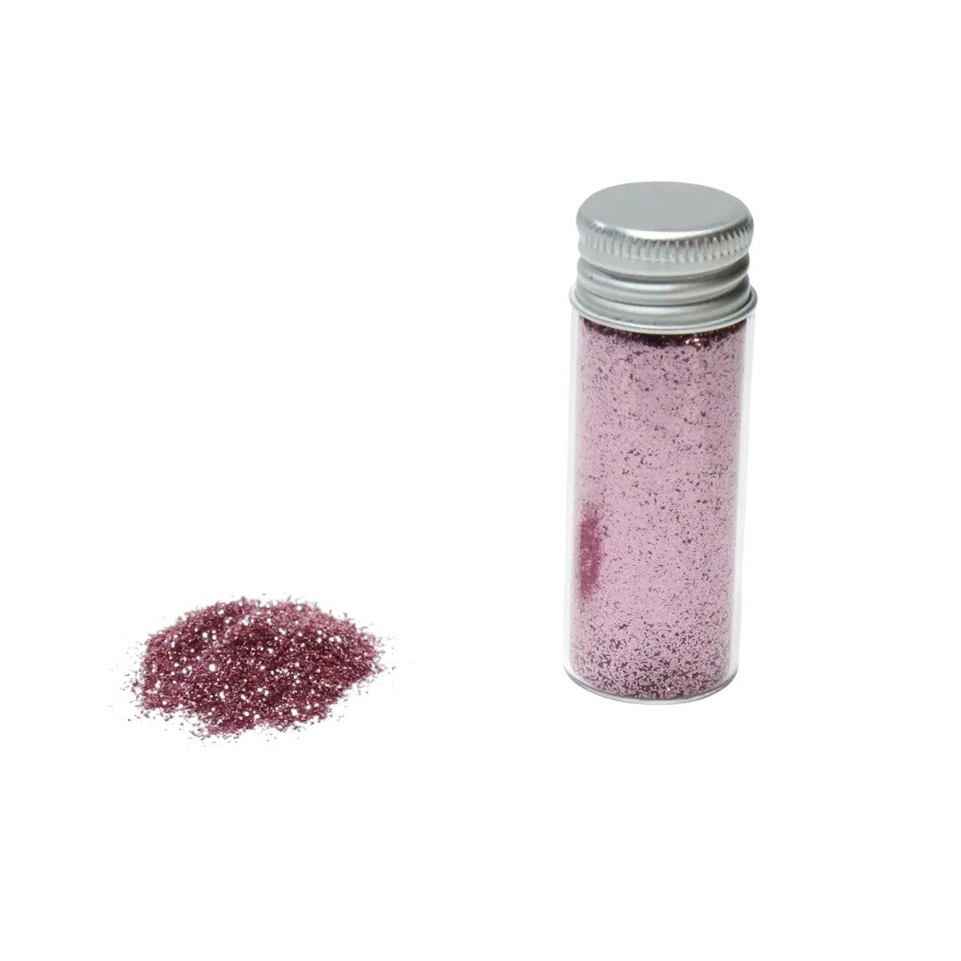 Escarcha comestible color rosa de Vallia Repostería en frasco de 10 g con muestra de polvo brillante sobre fondo blanco