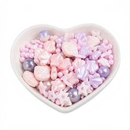 Kit de grageas Vallia Repostería con formas de conchas, estrellas y perlas en tonos pastel rosa y lila