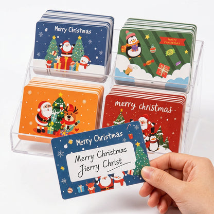 Set de tarjetas navideñas Vallia Repostería con diseños de Santa, renos y pingüinos y espacio para escribir nombres.
